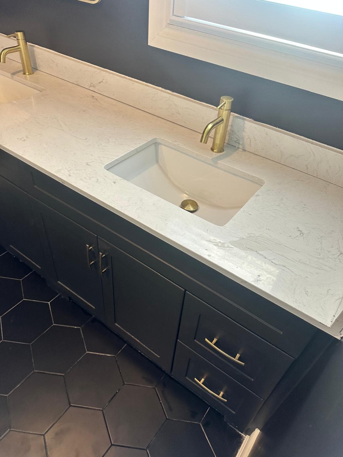 White counter with gold-tone faucet and undermount sink