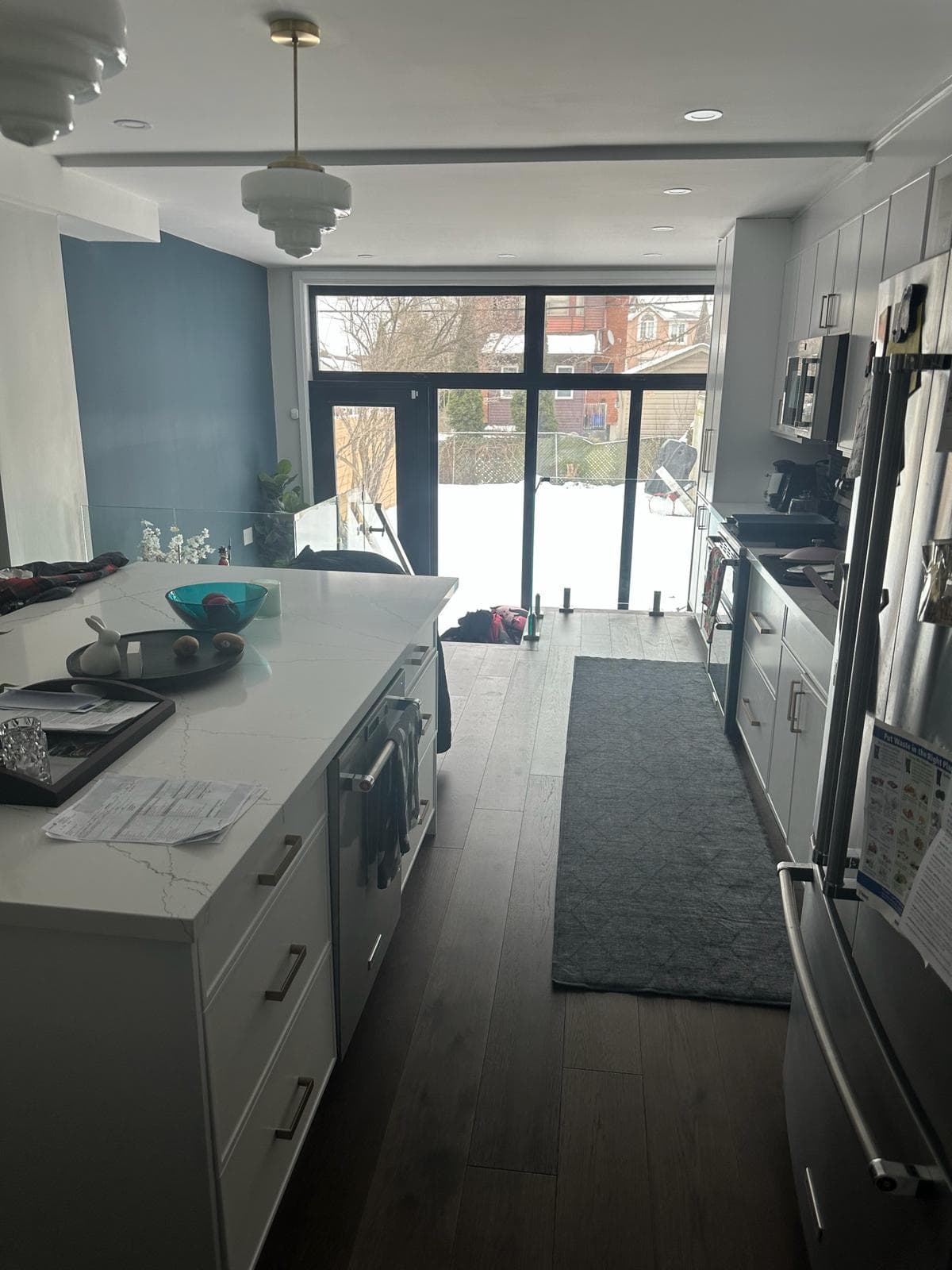 Toronto galley kitchen with marble-look counter, stainless appliances, and patio doors