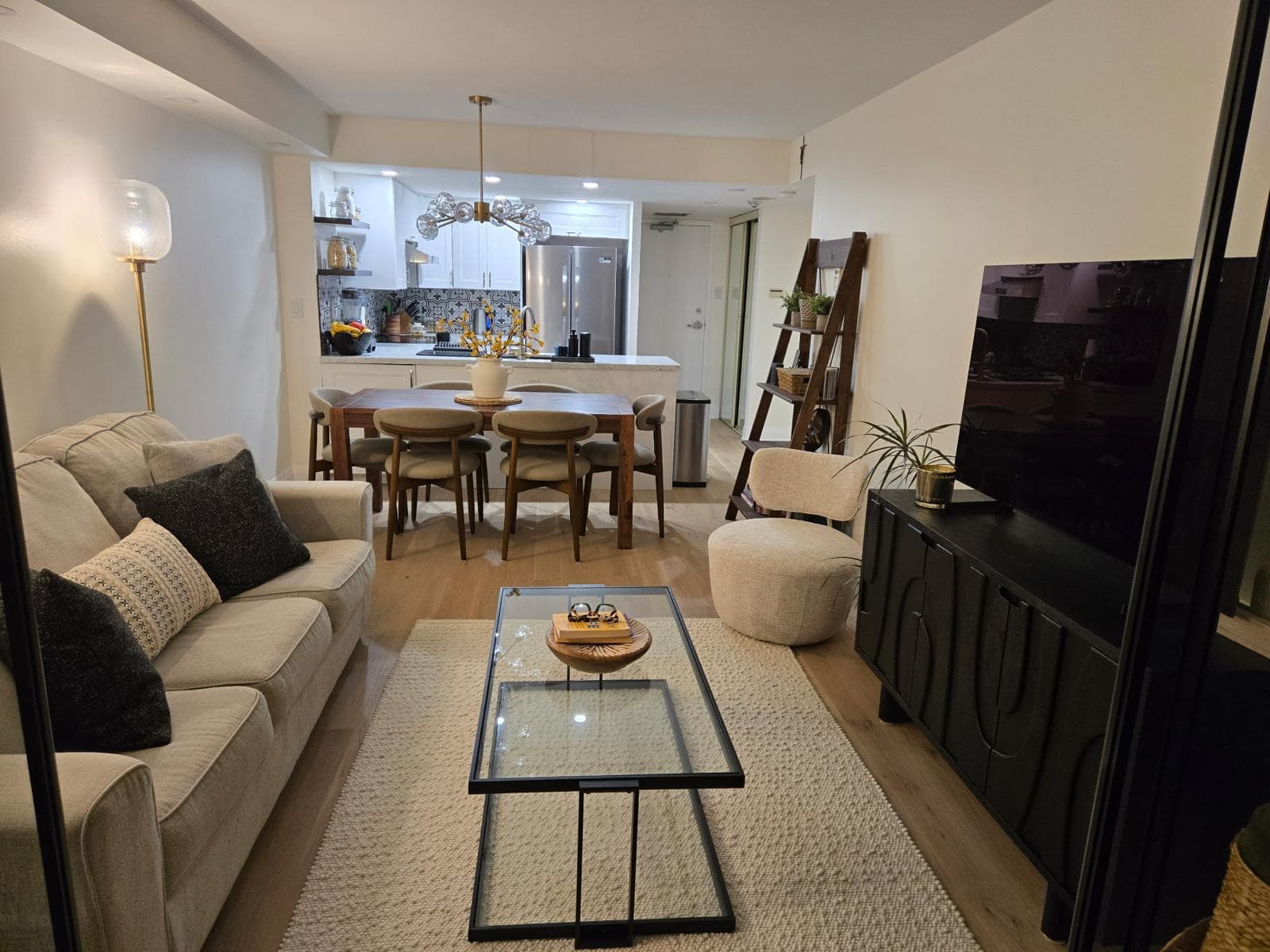 Open-concept living and dining view connected to the kitchen with hardwood floors