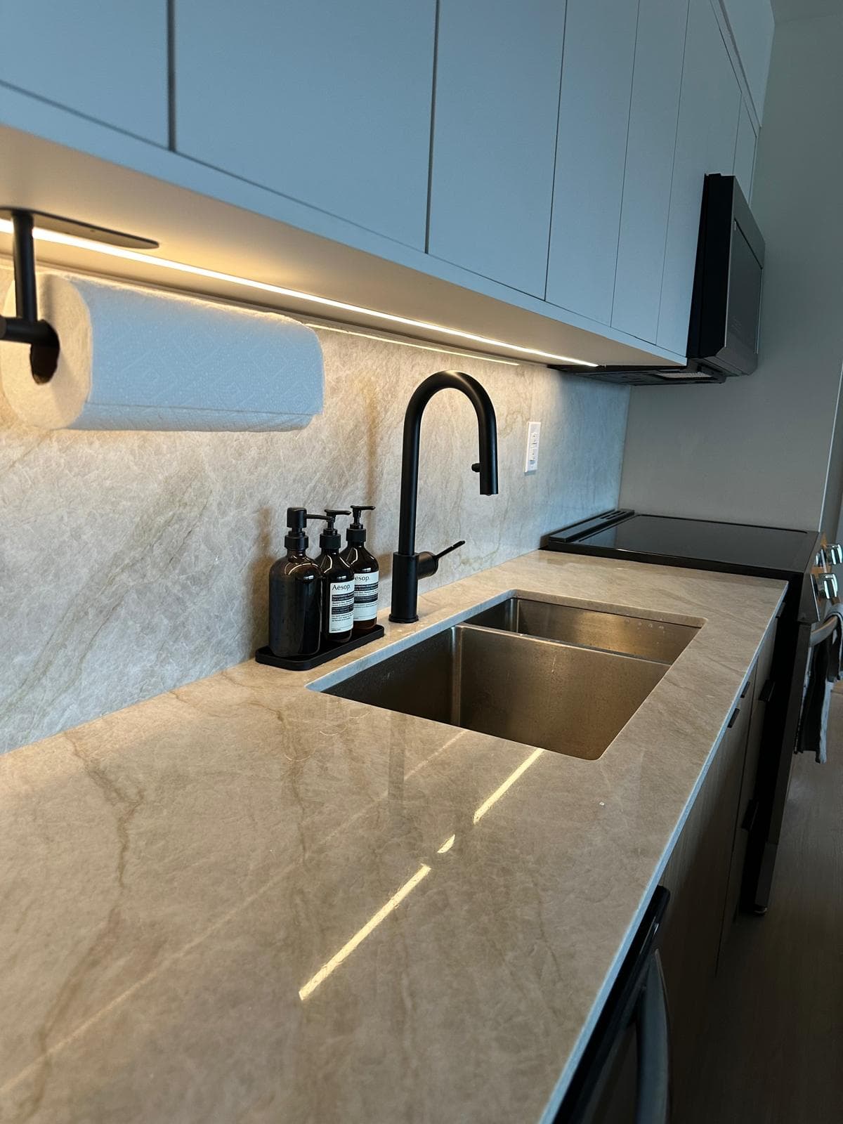 Quartzite kitchen counter detail with matte black faucet